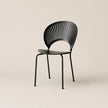 Black chair with fan-like backrest on a beige background