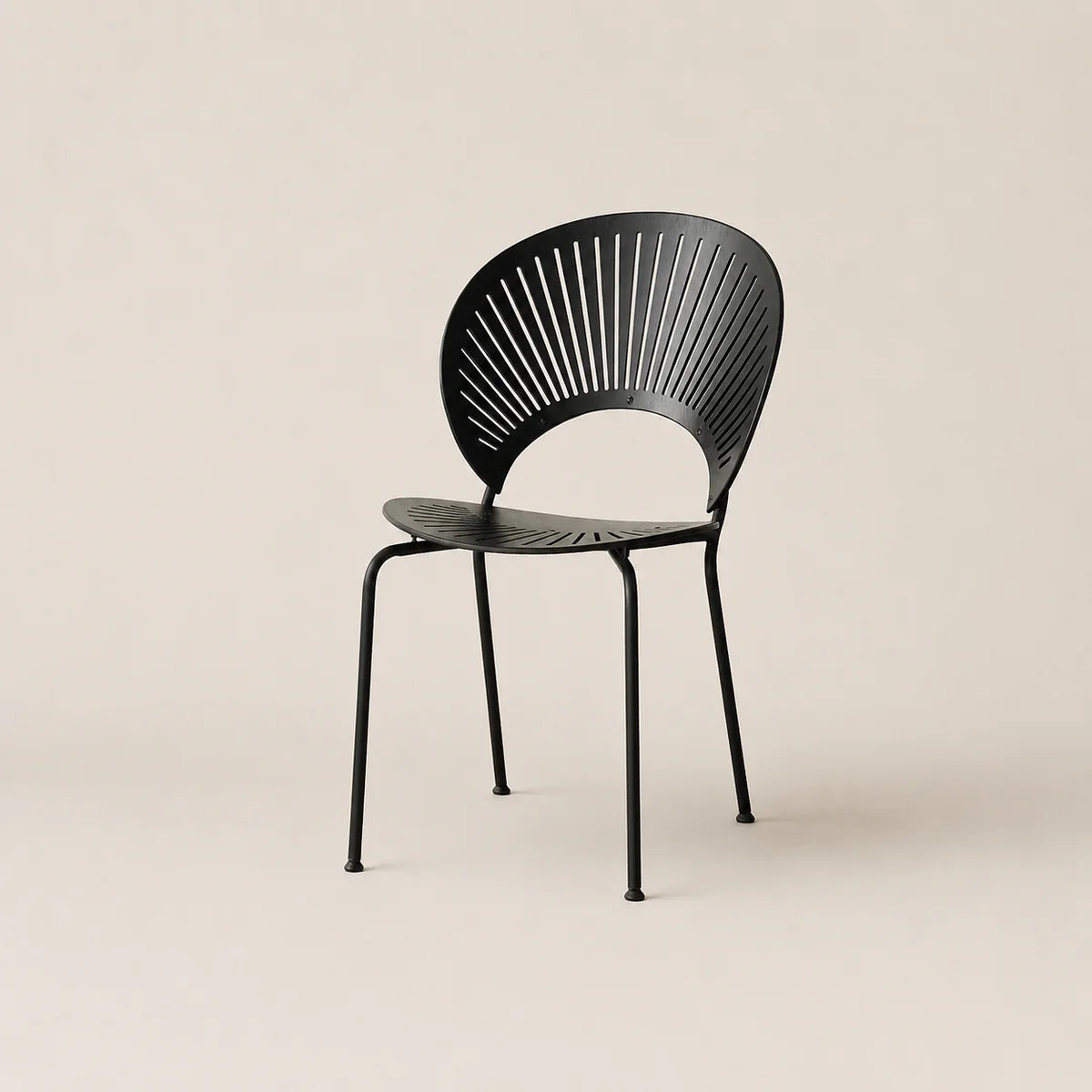 Black chair with fan-like backrest on a beige background