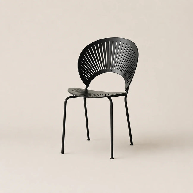 Black chair with fan-like backrest on a beige background