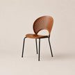 Wooden chair with black metal legs on a beige background