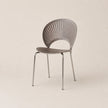 Modern chair with a metallic finish on a beige background
