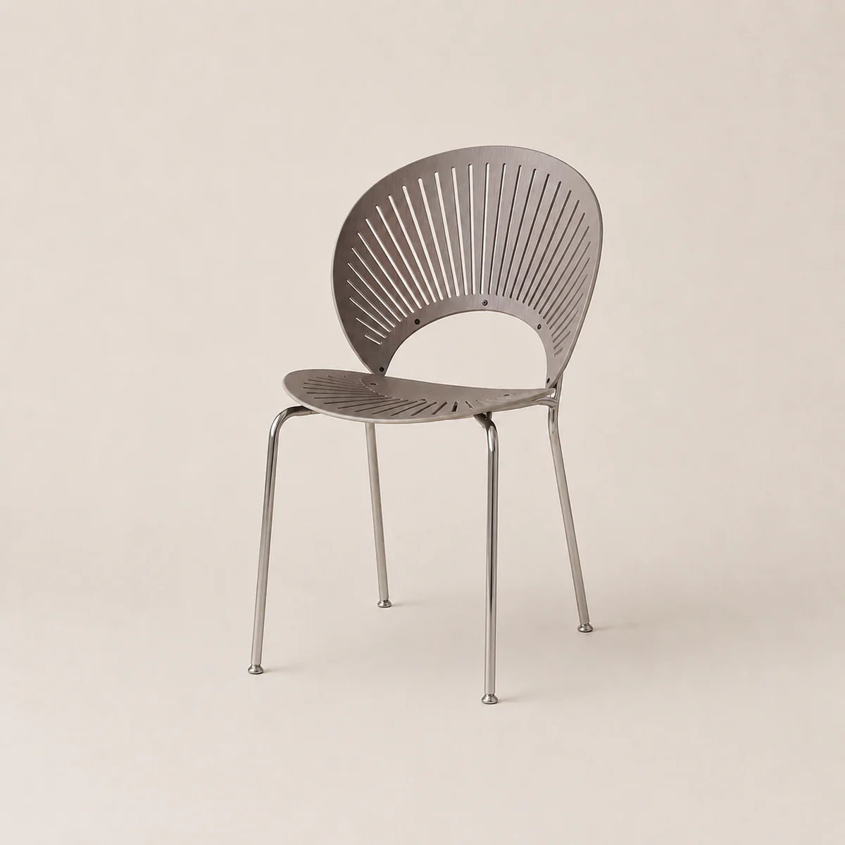 Modern chair with a metallic finish on a beige background