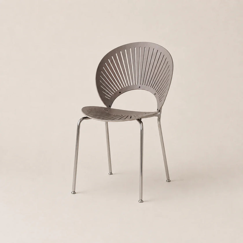 Modern chair with a metallic finish on a beige background