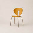 Yellow chair with metal legs on a beige background