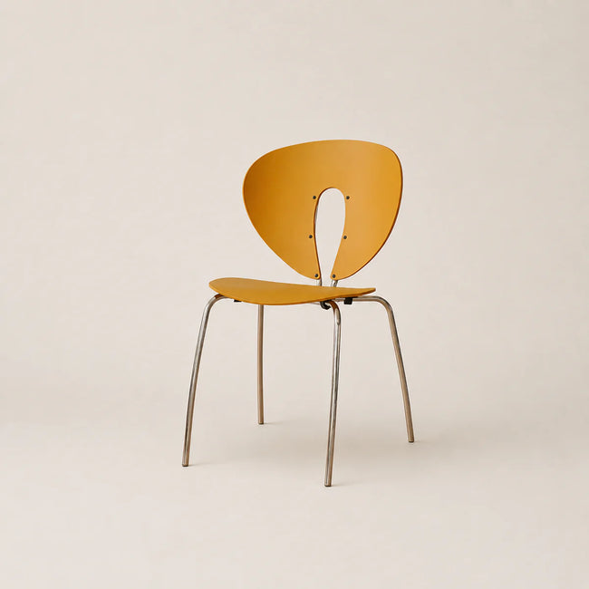 Yellow chair with metal legs on a beige background