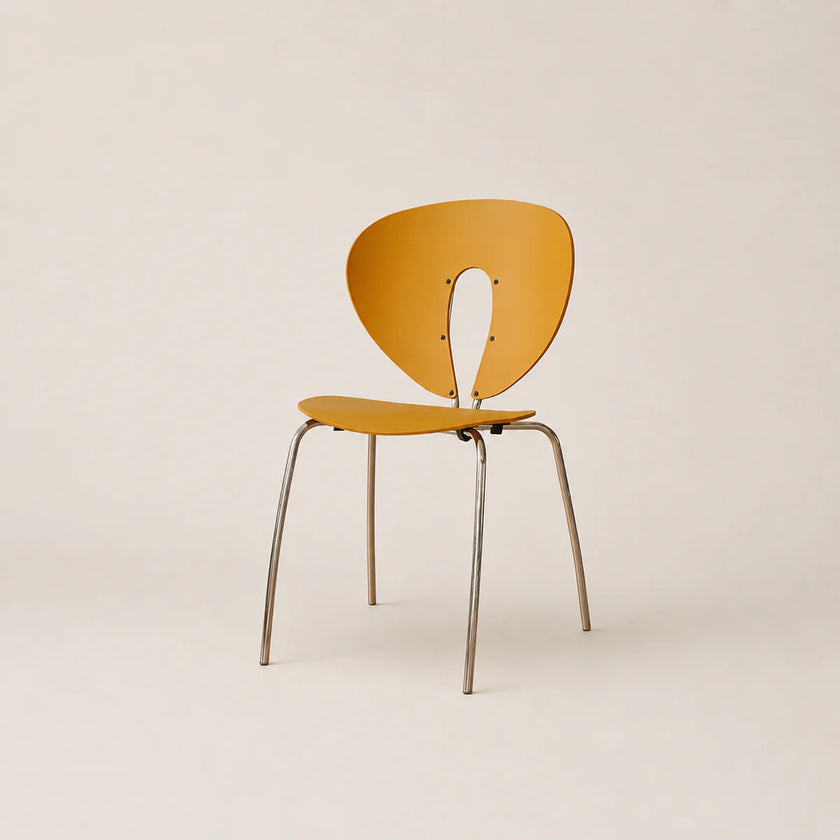 Yellow chair with metal legs on a beige background
