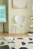Modern white metal dining room chair in a room with a glass table, books, and a wall art piece.