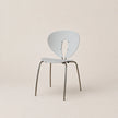 Modern chair with a light blue backrest and seat on a beige background