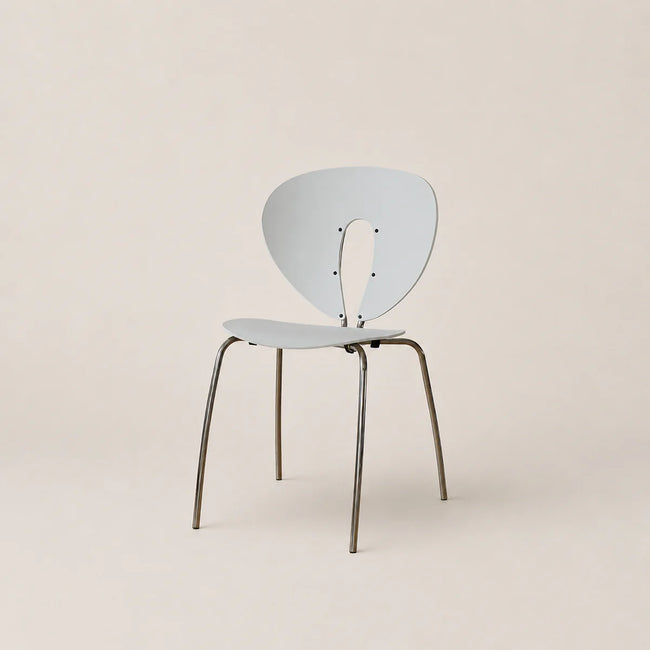 Modern chair with a light blue backrest and seat on a beige background