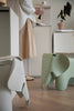 Two colorful elephant-shaped kids chairs in a kitchen setting with a person in the background.