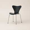 Black chair with metal legs on a beige background
