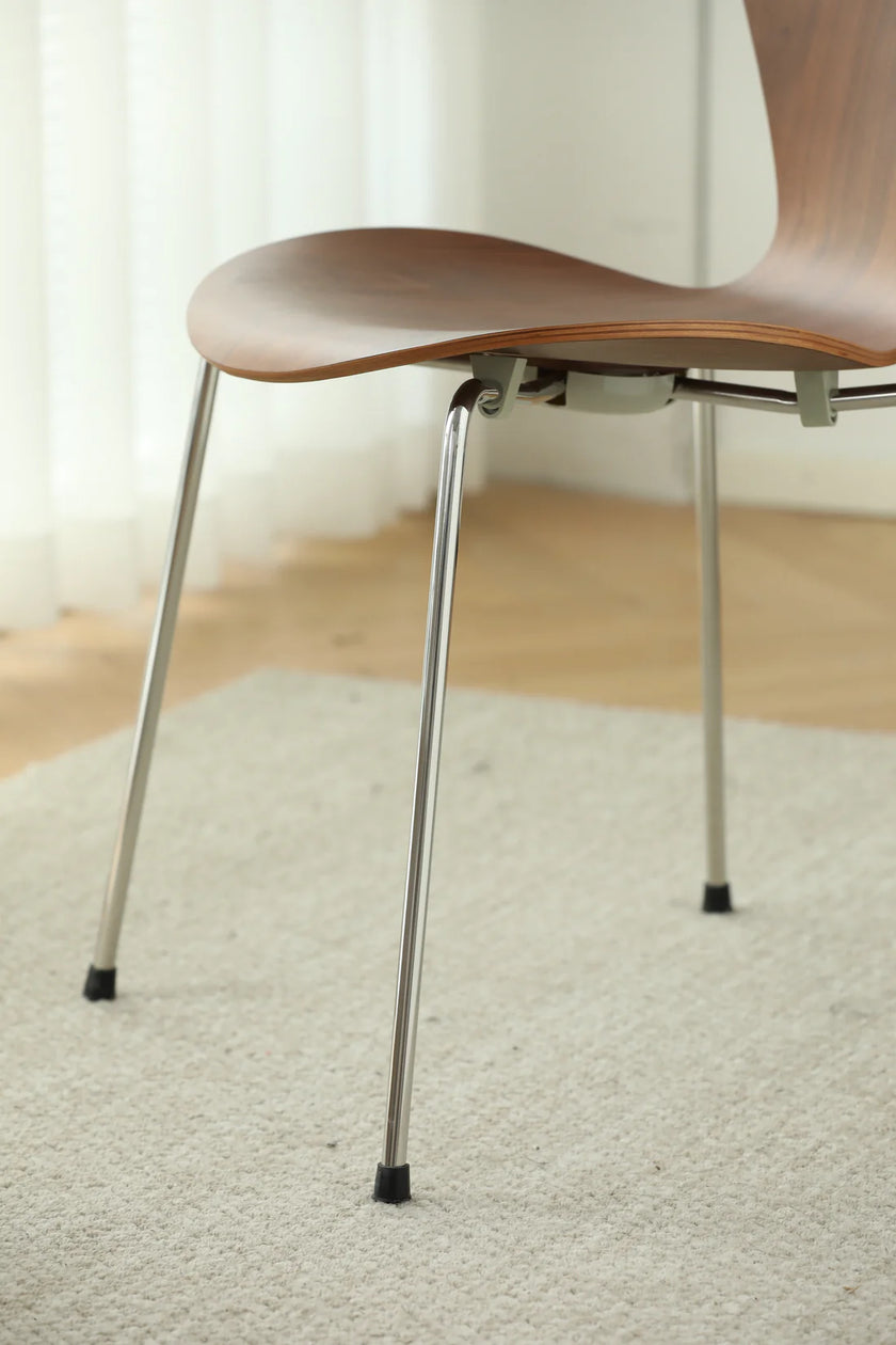 Wooden dining room chair with metal legs on a carpeted floor