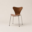 Brown chair with metal legs on a beige background