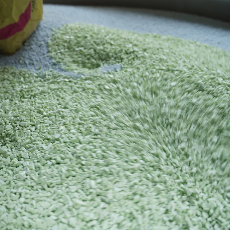 Green textured rug on a carpeted floor