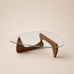 Glass coffee table with wooden base on a beige background