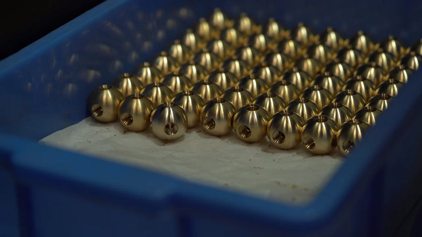 Close-up of gold beads in a blue container