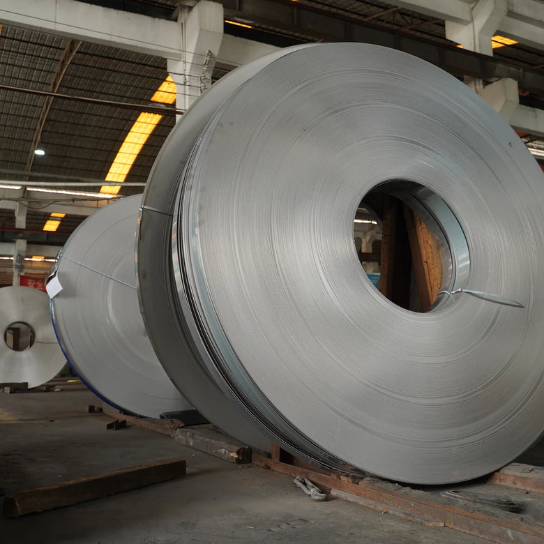 Large rolls of metal sheet in a warehouse setting