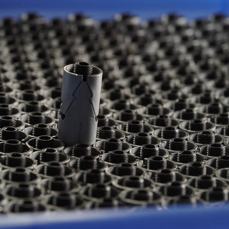 Small cylindrical object on a textured surface with a blue background