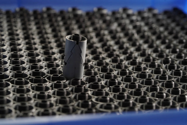 Small cylindrical object on a textured surface with a blue background