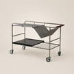 Metal trolley with shelves on a beige background