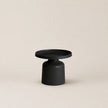 Black side table on a beige background