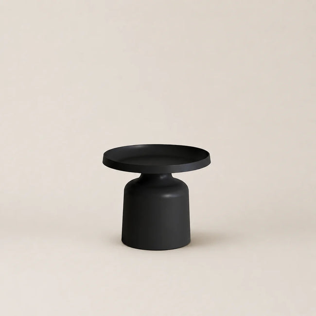 Black side table on a beige background