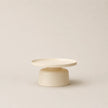 Minimalist ceramic table with two levels on a beige background