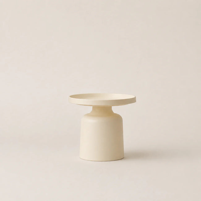 Minimalist cream-colored side table on a light beige background