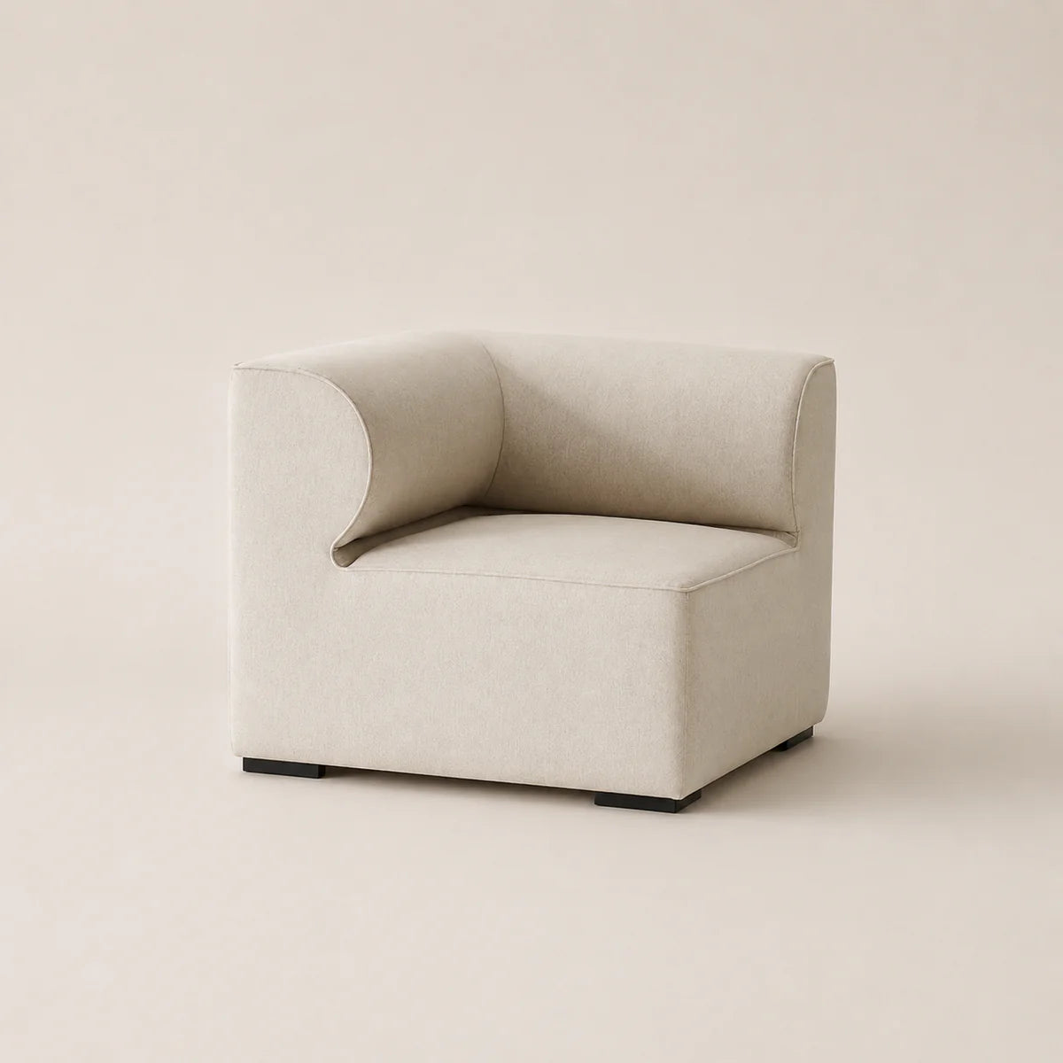 A modern low-profile accent chair upholstered in a light beige textured fabric, featuring a curved backrest and dark square feet, set against a solid warm beige background.