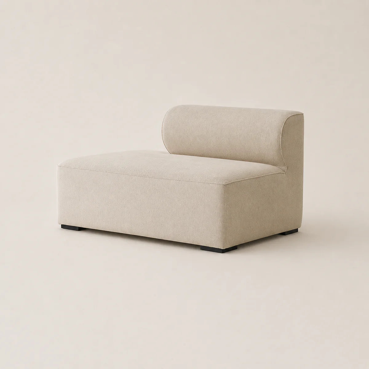 A modern low-profile modular sofa corner piece with a single chaise lounge seat, upholstered in a textured light beige fabric, shown against a solid warm beige background.