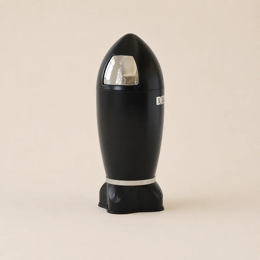 Black cylindrical device with a reflective surface on a beige background
