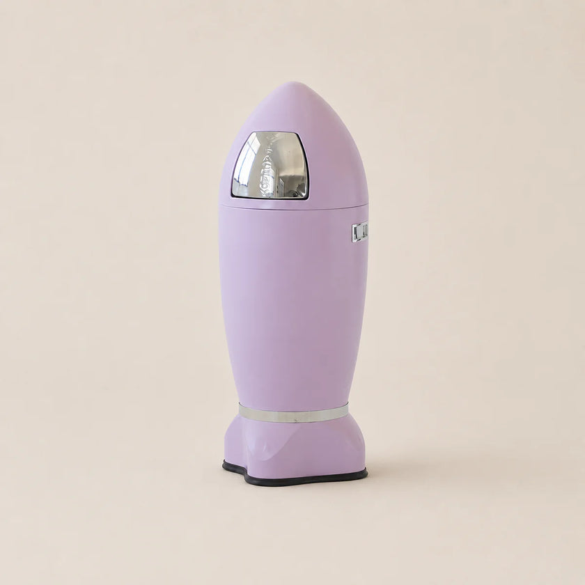 Purple cylindrical device with a reflective surface on a beige background