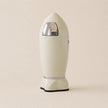 Beige trash can with metallic accents on a beige background