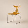 Yellow chair with transparent backrest on a beige background