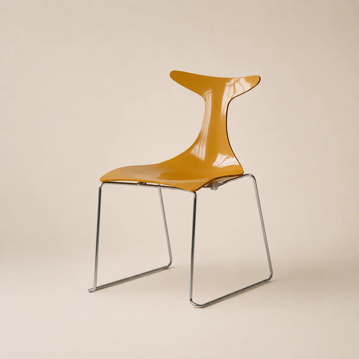 Yellow chair with transparent backrest on a beige background