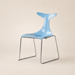 Modern blue chair with a unique design on a beige background