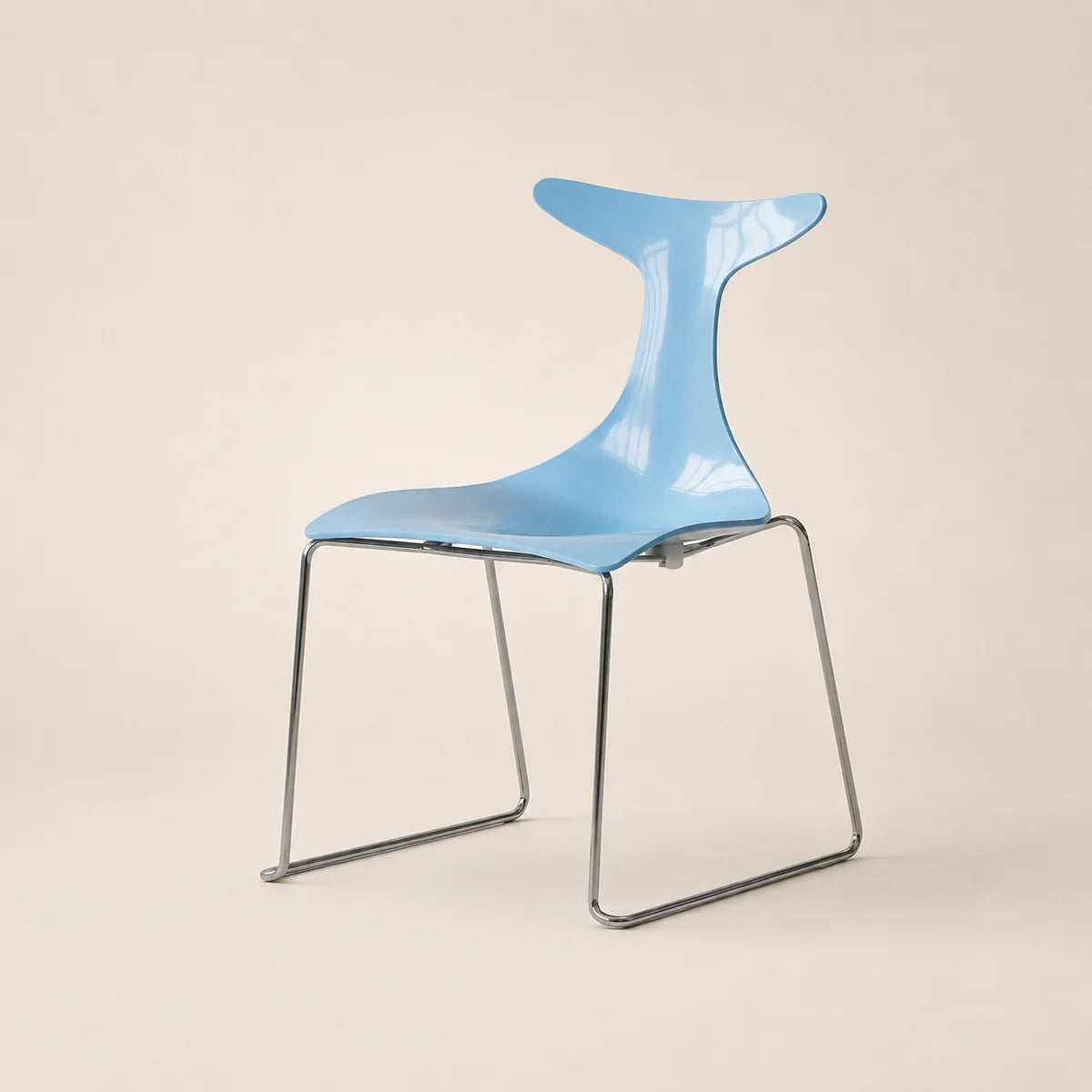 Modern blue chair with a unique design on a beige background
