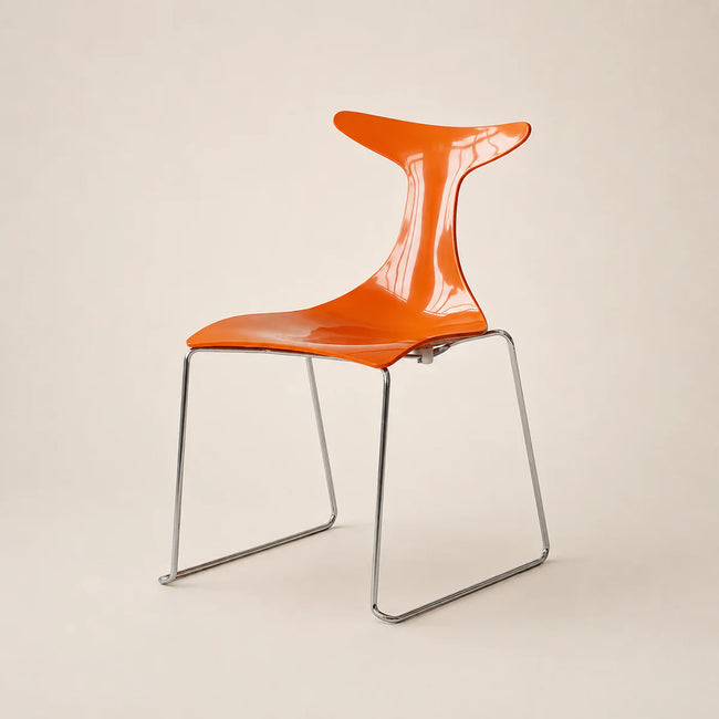 Orange chair with a transparent backrest on a beige background