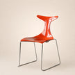 Orange chair with a transparent backrest on a beige background