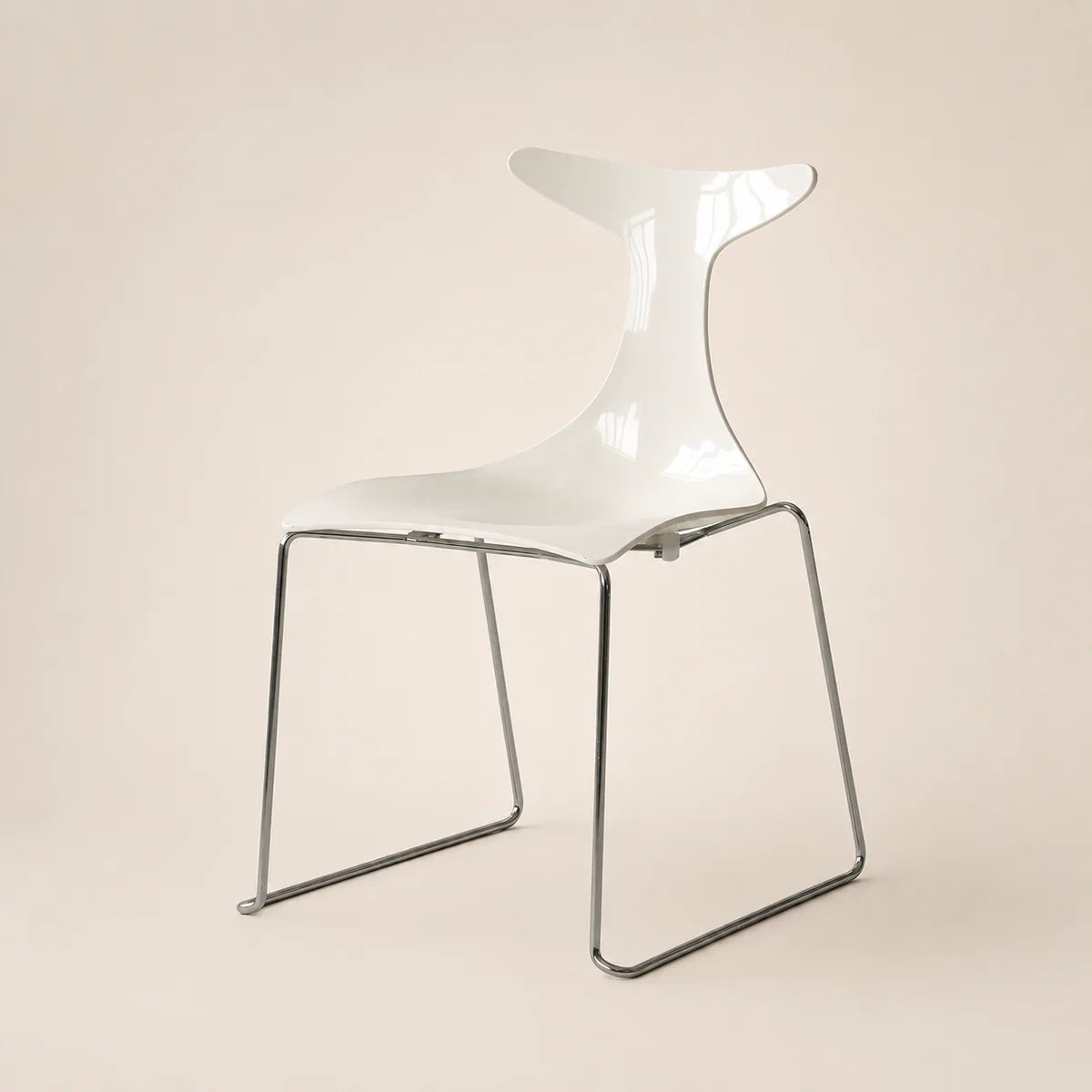 Modern white chair with a transparent backrest on a beige background