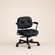 Black office chair on a beige background