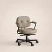 Beige office chair with black base on a beige background
