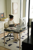 Lady sit office chair working at a desk with a computer in a home office setting