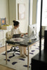 Lady sit office chair working at a desk with a computer in a home office setting