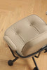 Beige office swivel arm chair cushion on a wooden floor