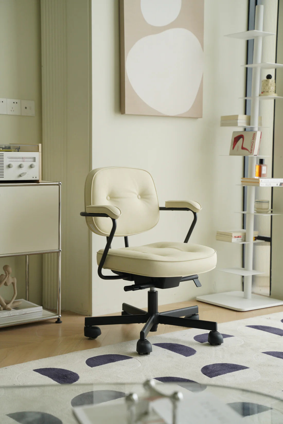 Beige office arm chair in a room with a abstract painting on the wall