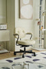 Beige office arm chair in a room with a abstract painting on the wall