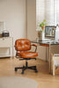 Brown office computer chair in a home office setting with a desk and computer.