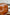 Close-up of a brown office leather swivel arm chair with a blurred background