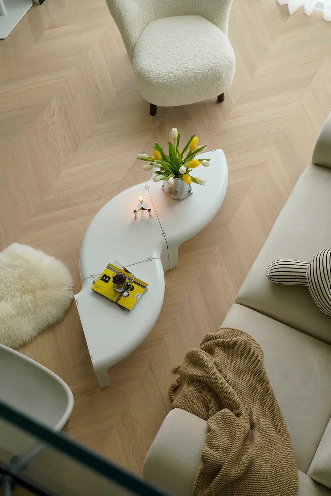 Living room with a white coffee table, sofa, and decorative items.